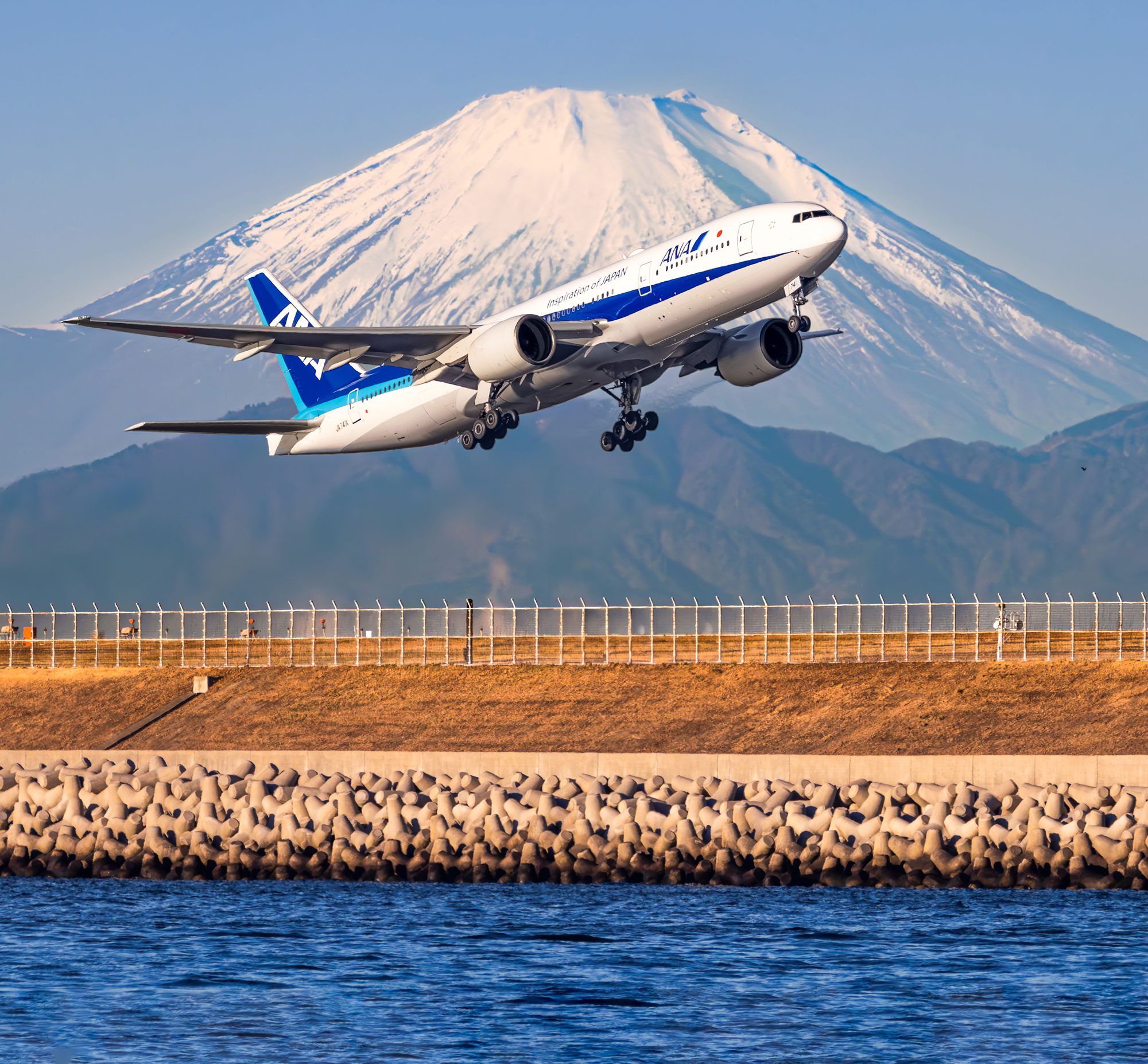 ANA Boeing 777 climbing out of Tokyo Haneda with snow-capped Mt. Fuji behind